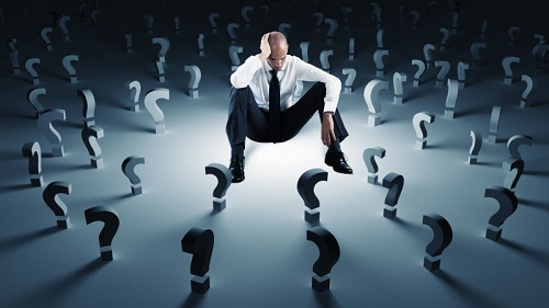 Businessman With Many Question Marks. Concept Of Failure And Problem