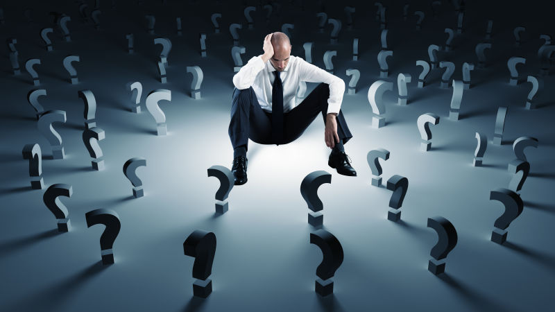 Businessman With Many Question Marks. Concept Of Failure And Problem
